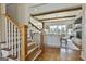 Elegant staircase leading to a spacious living room featuring exposed beams, fireplace and ample windows at 132 Platinum Rdg, Sharpsburg, GA 30277