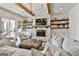 Bright living room with a stone fireplace, wooden ceiling beams, and neutral-toned furnishings at 132 Platinum Rdg, Sharpsburg, GA 30277