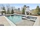 View of the pool with spa, steps and jets; an outdoor fireplace adds to the elegance of this backyard oasis at 132 Platinum Rdg, Sharpsburg, GA 30277