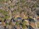 Drone eye view of a home nestled among trees with neighboring houses dotting the landscape at 321 Pleasant Valley Rd, Mcdonough, GA 30253