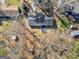Overhead view of cozy home featuring a dark roof, compact layout, and spacious lot with mature trees at 321 Pleasant Valley Rd, Mcdonough, GA 30253