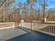 Back deck overlooking a lush yard, surrounded by trees at 321 Pleasant Valley Rd, Mcdonough, GA 30253