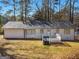 Backyard view of home featuring an outdoor deck and lush landscaping at 321 Pleasant Valley Rd, Mcdonough, GA 30253