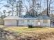 Backyard view of home featuring an outdoor deck and lush landscaping at 321 Pleasant Valley Rd, Mcdonough, GA 30253