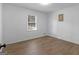 This bedroom features wood-look flooring, neutral walls, and a window providing natural light at 321 Pleasant Valley Rd, Mcdonough, GA 30253