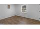 Bright bedroom with wood-look floors, window, and neutral walls at 321 Pleasant Valley Rd, Mcdonough, GA 30253