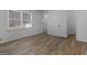 Cozy bedroom with wood-look floors, window, and neutral walls at 321 Pleasant Valley Rd, Mcdonough, GA 30253