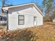 Exterior side view of home featuring white siding, a window and a white door at 321 Pleasant Valley Rd, Mcdonough, GA 30253