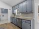 Well-lit kitchen with blue cabinets, stainless steel appliances, and wood-look floors at 321 Pleasant Valley Rd, Mcdonough, GA 30253