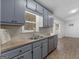 Well-lit kitchen featuring blue cabinets, stainless steel appliances, and mosaic backsplash at 321 Pleasant Valley Rd, Mcdonough, GA 30253
