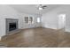 Spacious living room featuring a fireplace, ceiling fan, and natural light at 321 Pleasant Valley Rd, Mcdonough, GA 30253