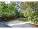 View of the fenced backyard from a deck, showing a tidy lawn area and trees providing privacy at 870 Monroe Ne Dr, Atlanta, GA 30308