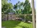 View of a balcony area with artificial turf and gold metal railings with lush trees in the background at 870 Monroe Ne Dr, Atlanta, GA 30308