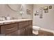 Bathroom featuring a dark vanity with granite countertop, a toilet and gallery wall art at 870 Monroe Ne Dr, Atlanta, GA 30308