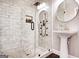 Bathroom featuring a white brick walk-in shower, patterned tile floor and pedestal sink at 870 Monroe Ne Dr, Atlanta, GA 30308
