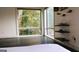 Bright bedroom featuring large window with outside view, sleek dark floors, and modern shelving at 870 Monroe Ne Dr, Atlanta, GA 30308