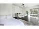 Spacious bedroom featuring hardwood floors, a daybed, ceiling fan and a large window overlooking trees at 870 Monroe Ne Dr, Atlanta, GA 30308