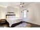 Cozy bedroom with a ceiling fan, neutral tones, and a colorful accent rug at 870 Monroe Ne Dr, Atlanta, GA 30308