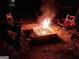 Campfire ablaze in a stone firepit surrounded by chairs, creating a cozy outdoor gathering space at 870 Monroe Ne Dr, Atlanta, GA 30308