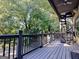 Spacious deck with dark railings, a spiral staircase, and view of lush greenery at 870 Monroe Ne Dr, Atlanta, GA 30308