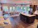 Open-concept living room with hardwood floors, large windows, modern furnishings, and a granite kitchen island at 870 Monroe Ne Dr, Atlanta, GA 30308
