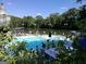 Large community pool overlooking a pond and shaded by mature trees and lush shrubbery at 870 Monroe Ne Dr, Atlanta, GA 30308