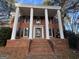 Classic two-story brick home with black shutters and stately white columns on the front porch at 1241 Mount Vernon Dr, Lawrenceville, GA 30044