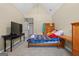 Cozy bedroom featuring vaulted ceilings, carpet floors, and a full-size bed with a plaid blanket at 45 George Wynn Rd, Palmetto, GA 30268