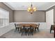 Elegant dining room with a beautiful chandelier and a rustic wooden table at 45 George Wynn Rd, Palmetto, GA 30268