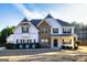 Charming two-story home featuring stone accents, white siding, and lush landscaping at 45 George Wynn Rd, Palmetto, GA 30268