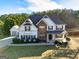 Beautiful two-story home with a combination of siding and stone, complemented by black shutters and a well-manicured lawn at 45 George Wynn Rd, Palmetto, GA 30268