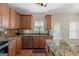 Well-equipped kitchen features granite countertops, wood cabinets, stainless steel appliances, and a functional island at 45 George Wynn Rd, Palmetto, GA 30268
