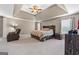 Spacious main bedroom with tray ceiling, carpet, and a cozy sitting area at 45 George Wynn Rd, Palmetto, GA 30268