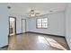 A bedroom featuring wood-look tile flooring, a ceiling fan, and natural lighting at 6187 Radford Dr, Riverdale, GA 30296