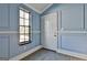 Inviting entryway featuring light blue walls, wood-look flooring, and a bright window at 6187 Radford Dr, Riverdale, GA 30296