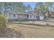Inviting one-story home with brick accents and a manicured lawn surrounded by mature trees at 6187 Radford Dr, Riverdale, GA 30296