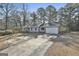Well-maintained single-level house with attached garage and a long driveway at 6187 Radford Dr, Riverdale, GA 30296