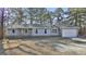 Charming single-story home with light blue siding, brick accents, and an attached garage at 6187 Radford Dr, Riverdale, GA 30296
