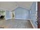 Spacious living room with light blue walls, white trim, and hardwood floors at 6187 Radford Dr, Riverdale, GA 30296