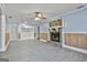 Open living room featuring a stone fireplace, wood-look tile flooring, and blue accent walls at 6187 Radford Dr, Riverdale, GA 30296