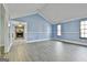 Bright living room featuring a stone fireplace and abundant natural light from large windows at 6187 Radford Dr, Riverdale, GA 30296