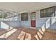 Cozy covered patio featuring brick flooring, exterior door, and window with ornate metal security bars at 6187 Radford Dr, Riverdale, GA 30296