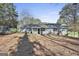 Exterior rear view of home with fenced yard and mature trees at 6187 Radford Dr, Riverdale, GA 30296