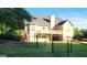 Two-story home with a wooden deck, fenced yard, and a well-manicured lawn at 35 Abelia Dr, Covington, GA 30014