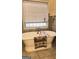 Bright bathroom features a soaking tub under window with tile flooring at 35 Abelia Dr, Covington, GA 30014