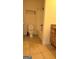 Bright bathroom featuring tile floors, a combination shower and tub, and a wooden vanity at 35 Abelia Dr, Covington, GA 30014