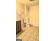 Bright bathroom with a toilet, shower, shelving, and wood vanity at 35 Abelia Dr, Covington, GA 30014