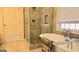 Bright bathroom features a glass shower and soaking tub with tile flooring at 35 Abelia Dr, Covington, GA 30014