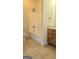 Bathroom featuring tile flooring, a shower-tub combo, and a wooden vanity at 35 Abelia Dr, Covington, GA 30014