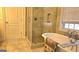 Upscale bathroom with tile, glass shower, standalone tub and modern fixtures at 35 Abelia Dr, Covington, GA 30014